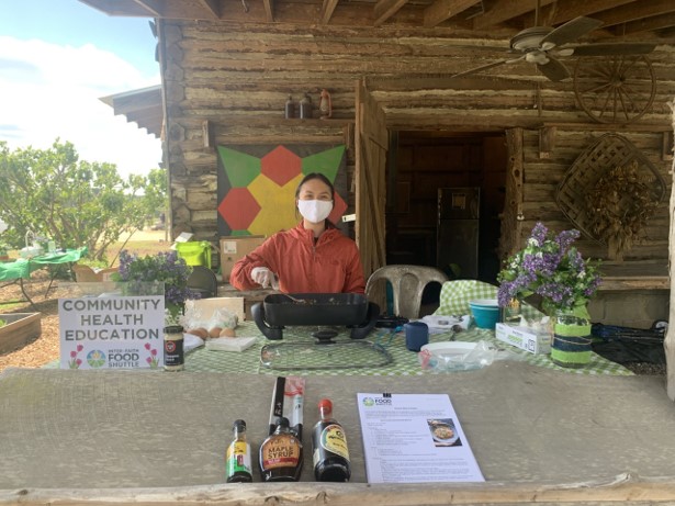 Lady providing health lessons to the community at a table