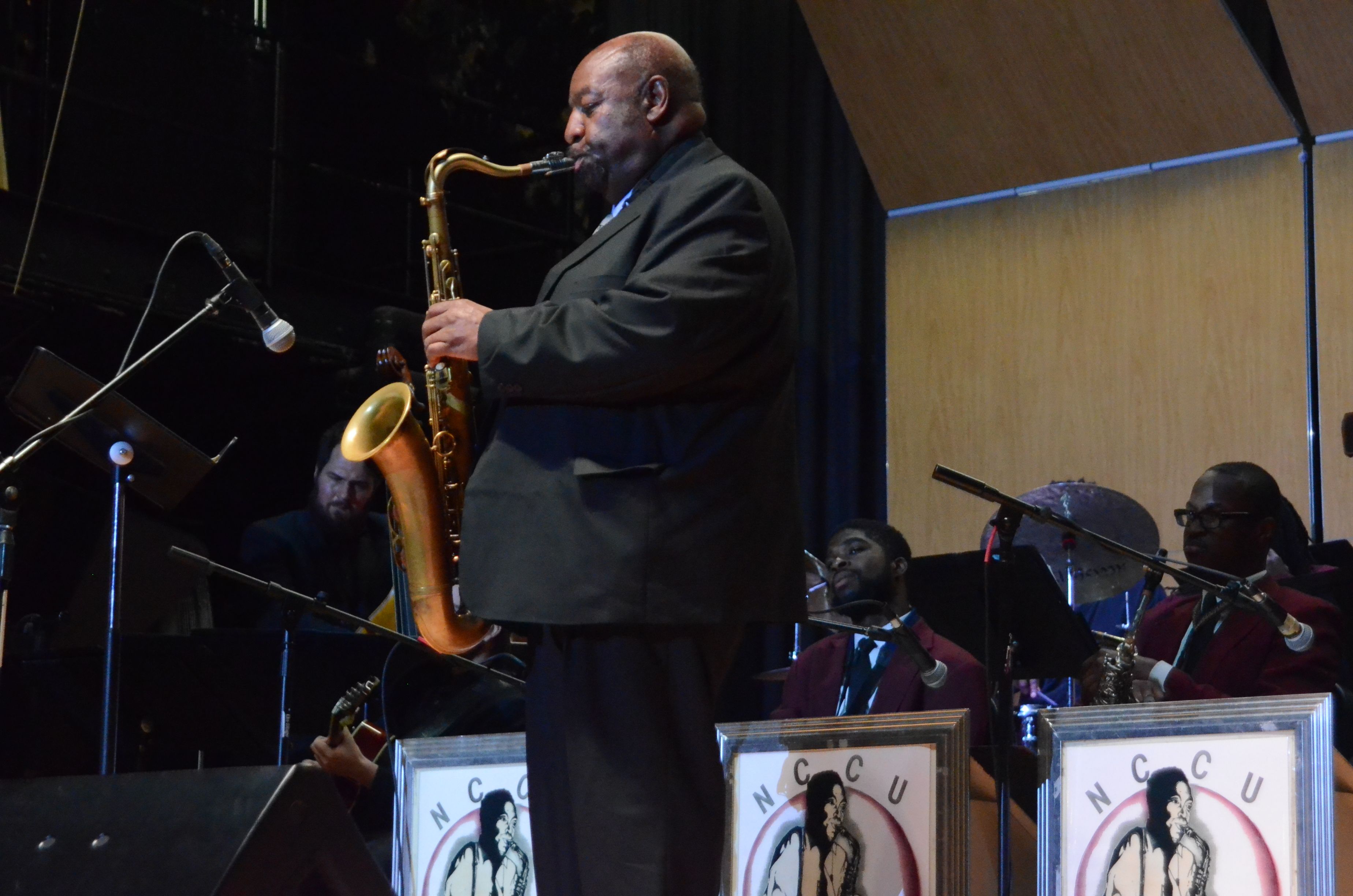 Ira Wiggins playing his sax on stage