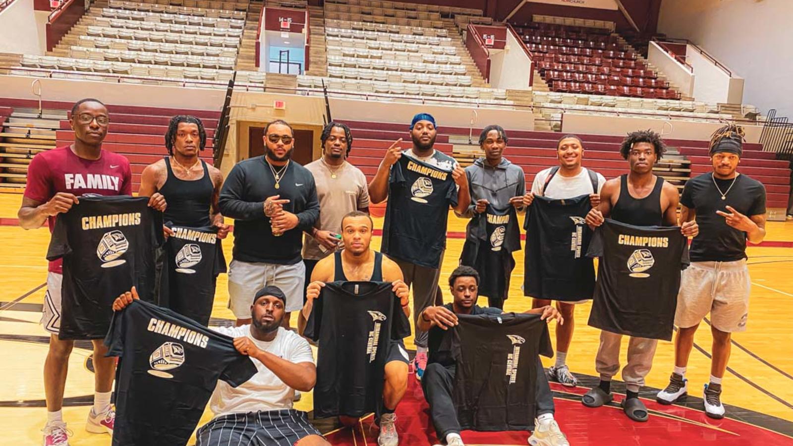 Basketball team holding up shirts