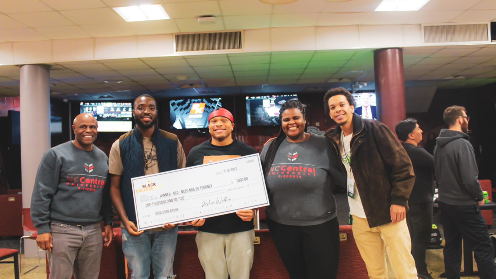 eSports gamers posing with check