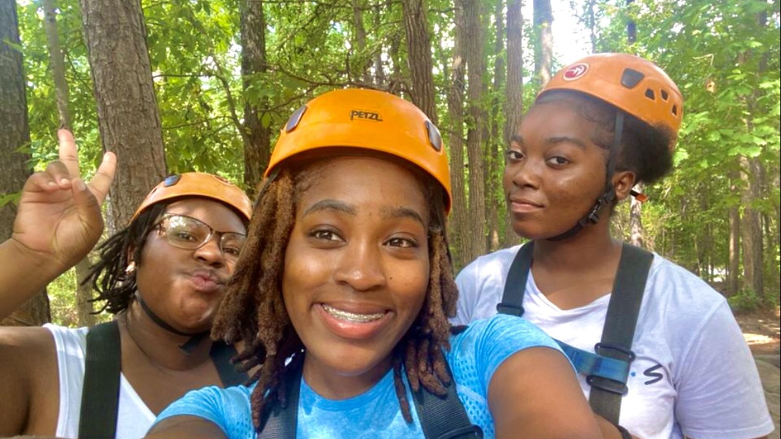 Students with helmets ready to zip line