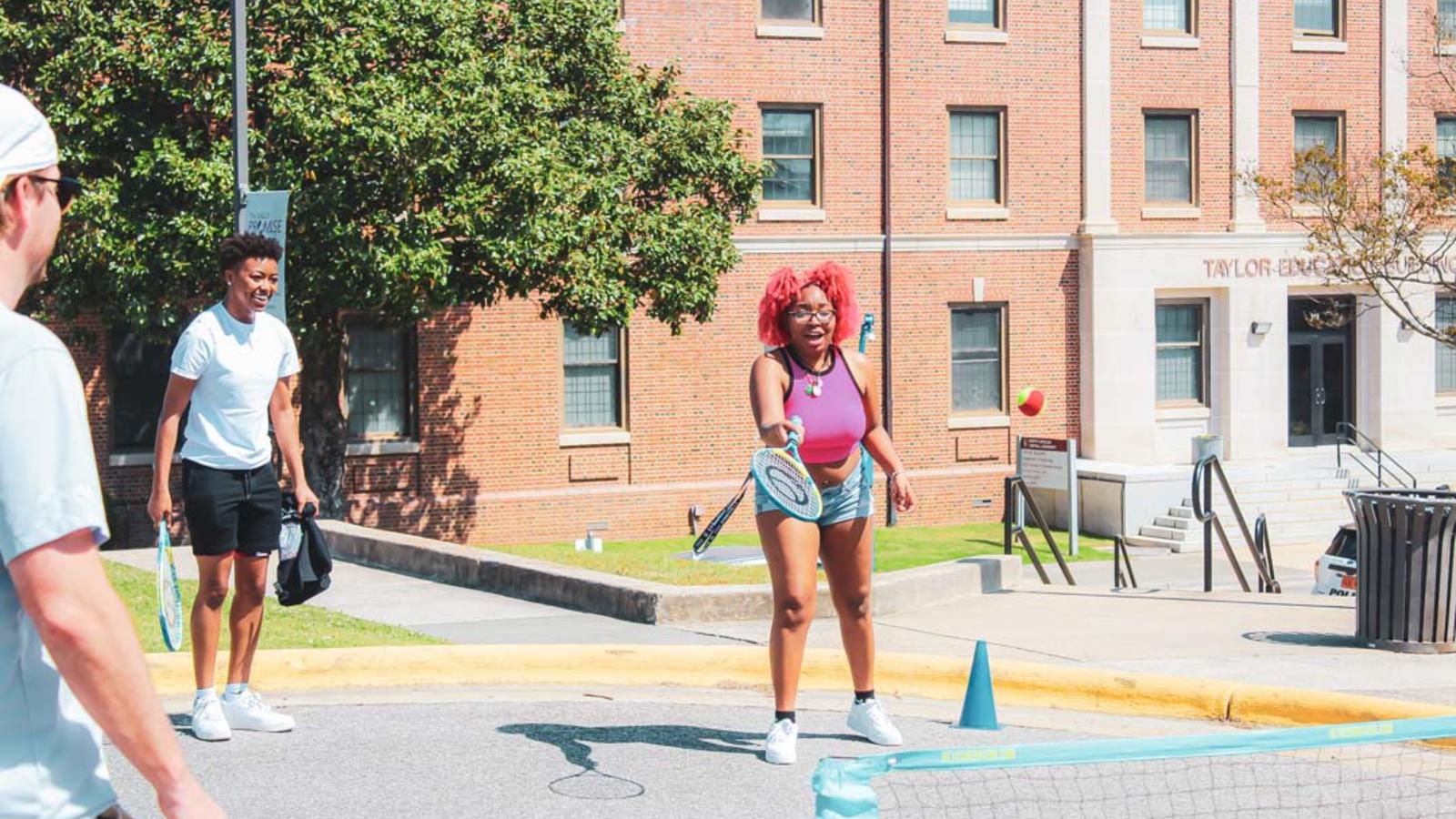 Student playing tennis