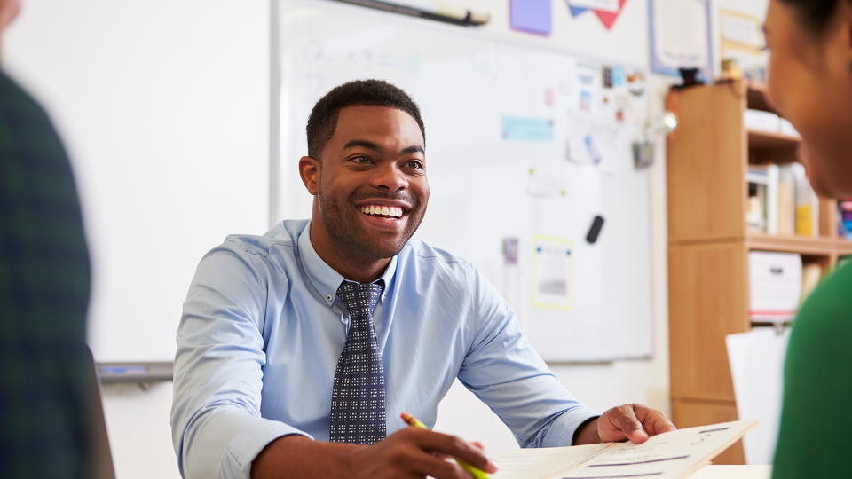 Student Smiling at a desk