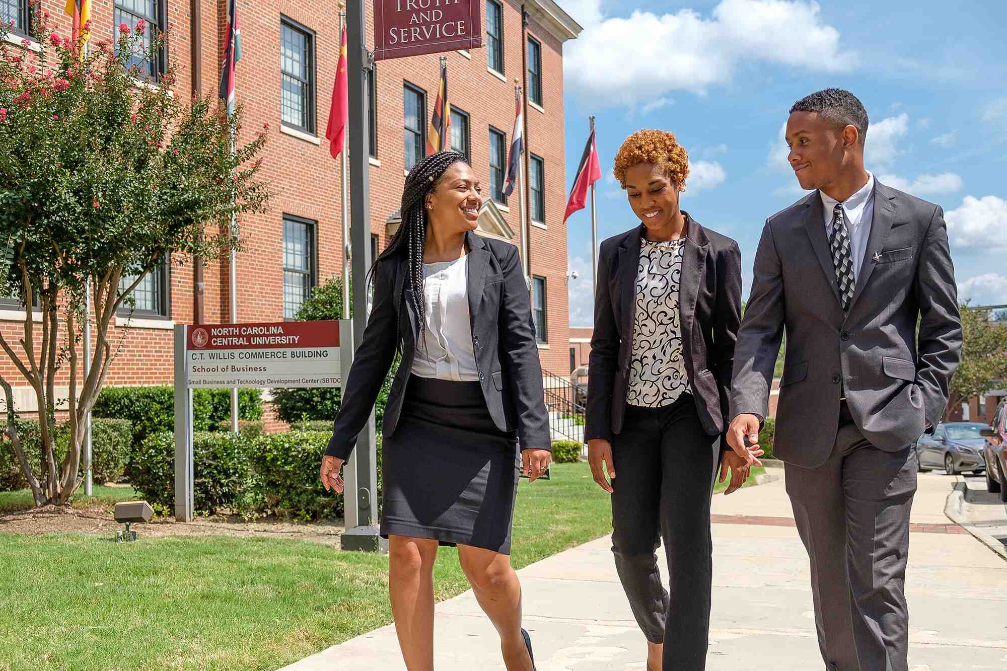 Students walking outside the school of business.