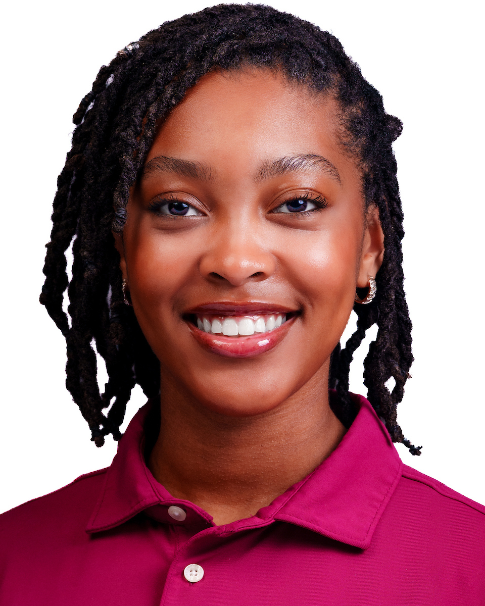 Portrait of a Christyn Hurey smiling North Carolina Central University Chancellor’s Ambassador wearing a maroon polo shirt.