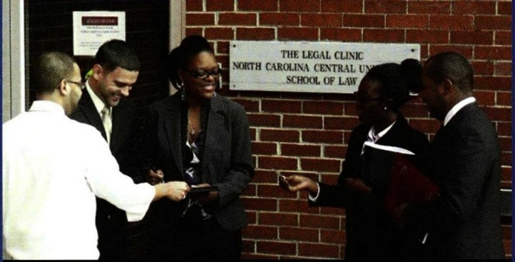 Image of people standing outside the NCCU Legal Clinic building