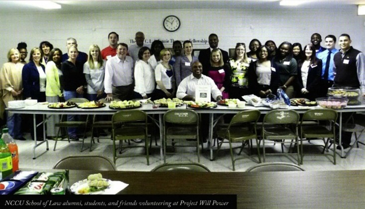 Image of Clinical Legal team standing behind a table