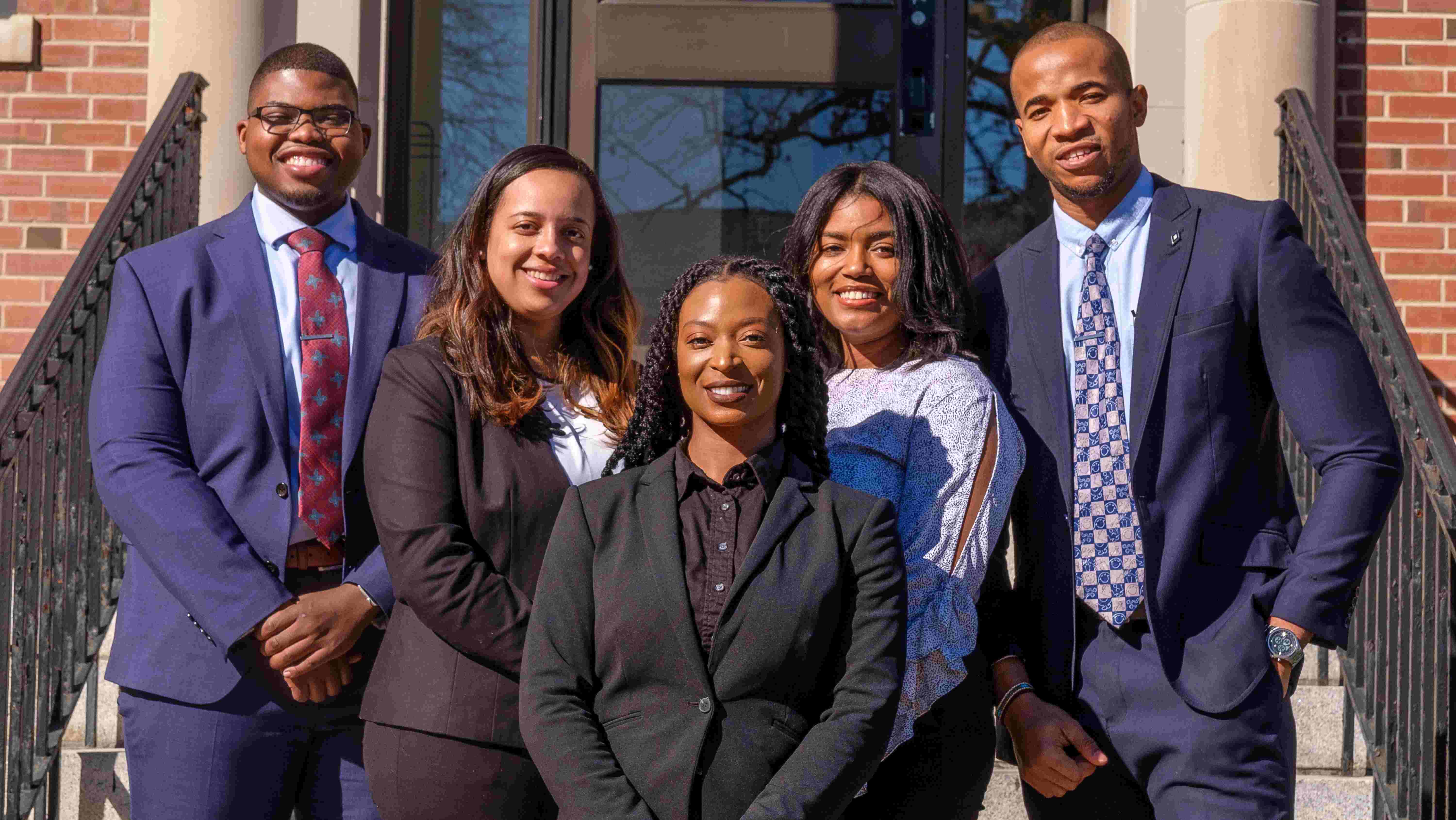 NCCU Business students standing on steps looking at camera.