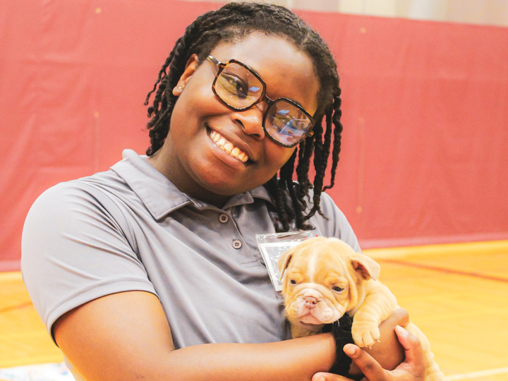 Student holding puppy