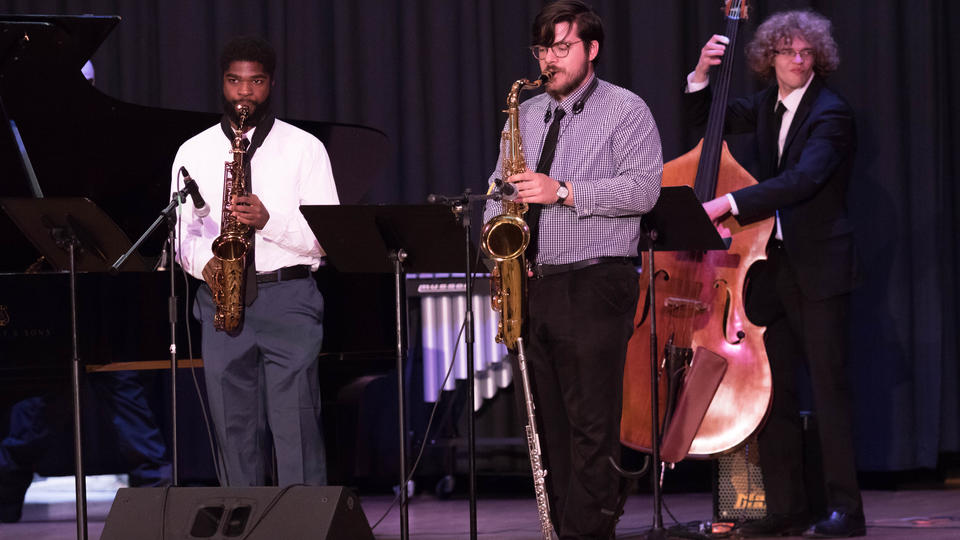 Jazz combo band playing with percussion in the background