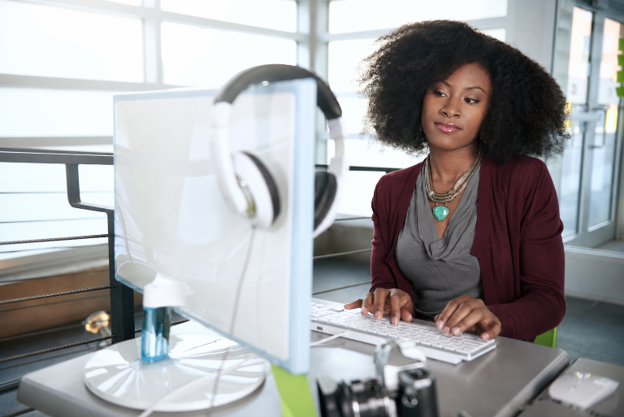 Image of a woman sitting at a computer typing