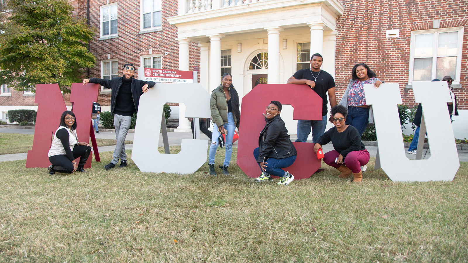 Students outside in front NCCU letters