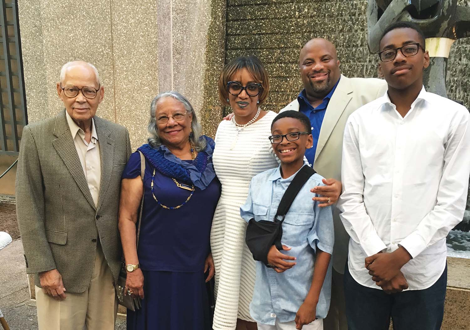 Mausi started the Dome Group, LLC, with his wife, Lesleigh, a former teacher and secondary school administrator, in 2009. (Pictured left to right) Grandparents Wanda and Nathan Garrett, Sr. wife Lesleigh Mausi, son Ahmad, Sulaiman Mausi and son Sulaiman Jr. Inset: Mausi celebrating his graduation day with his great grandfather, Dr. York D. Garrett. 