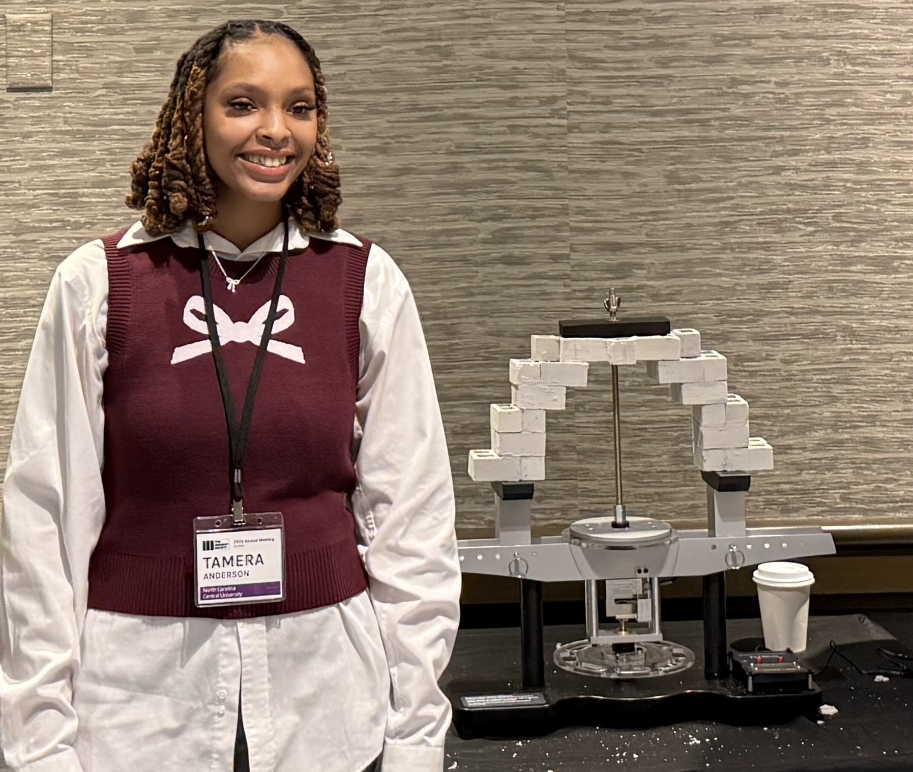 Tamera Anderson poses with the bridge that won her 'Best Presentation' at The Masonry Society's Student Bridge Competition