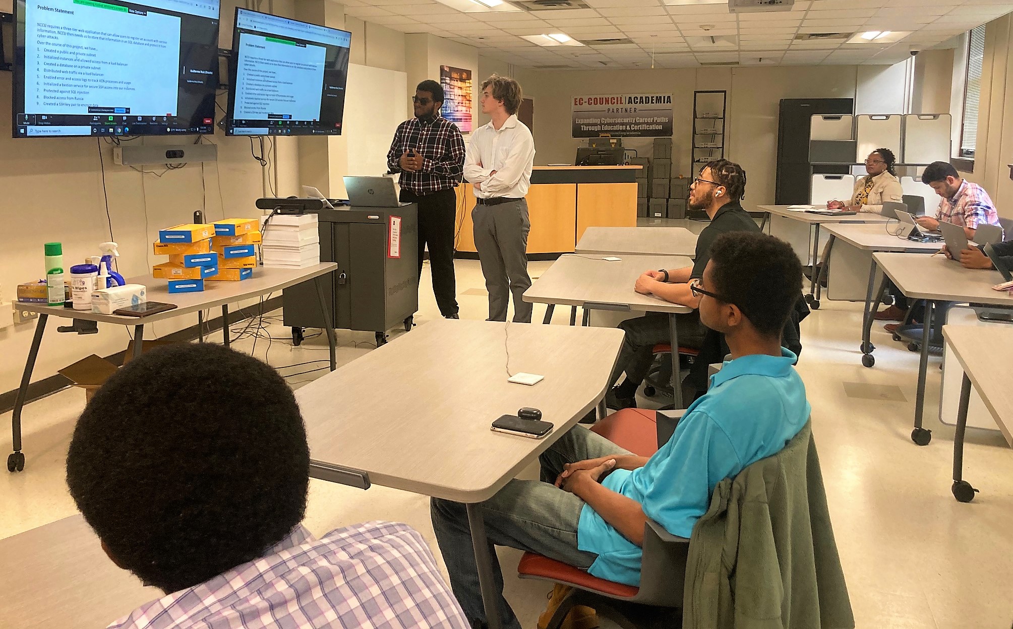 Students giving a presentation at a Cybersecurity competition