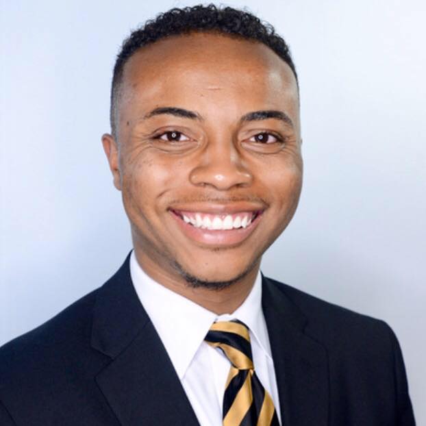Picture of Joshua Tilman, african american male with a black blazer and black and gold tie, with white shirt.