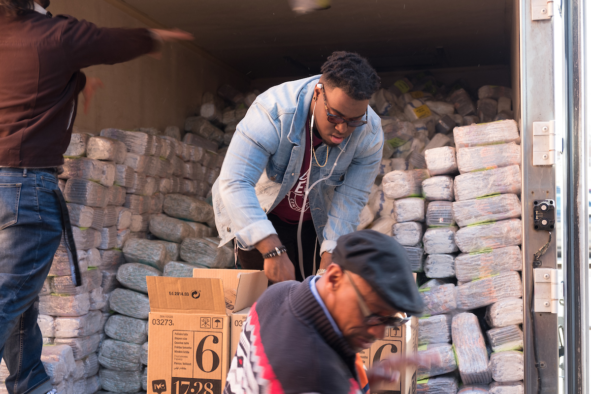 Student unloading supplies from tryck