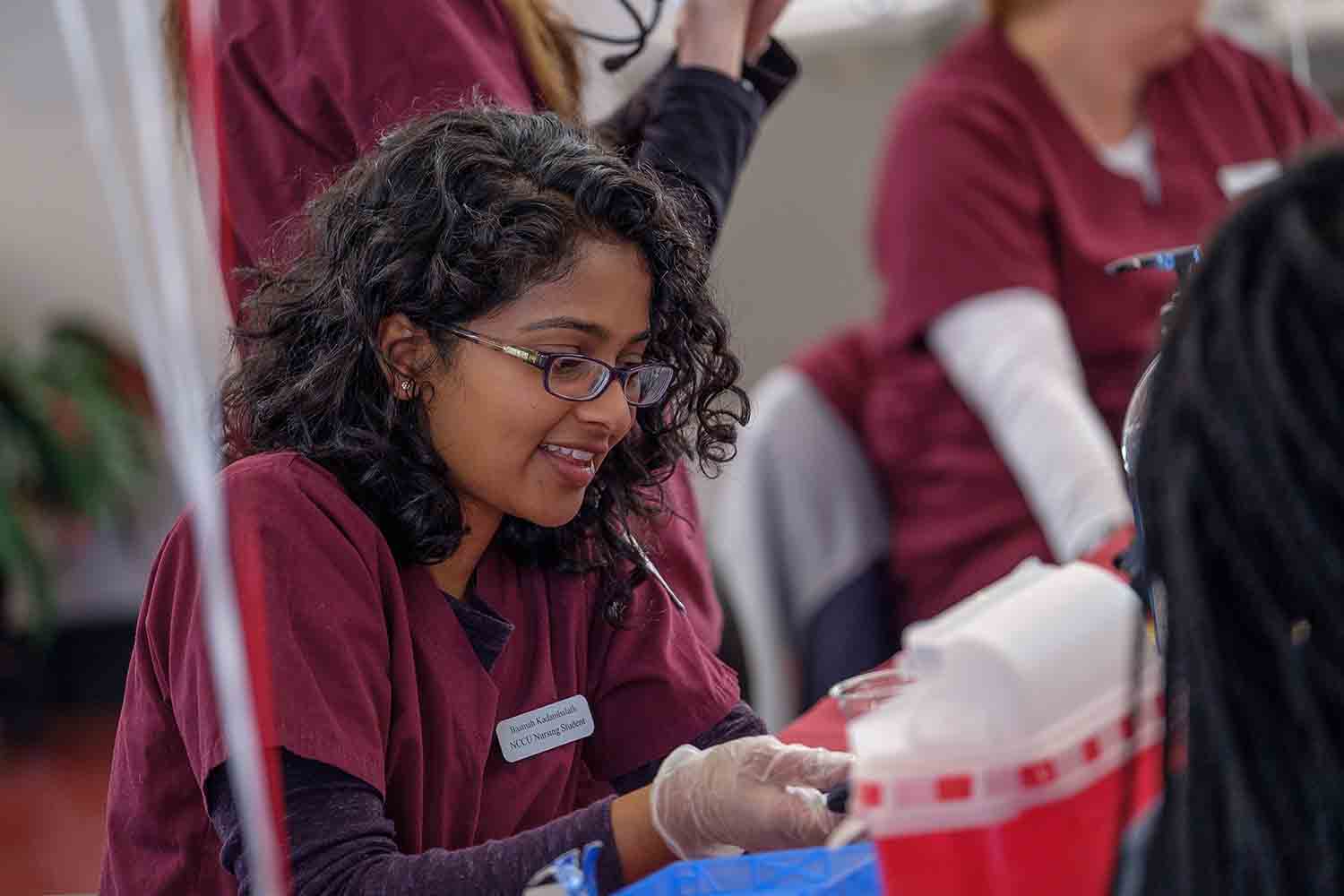 Nursing student helping student