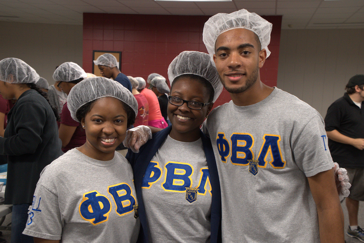 Students Smiling while Volunteering