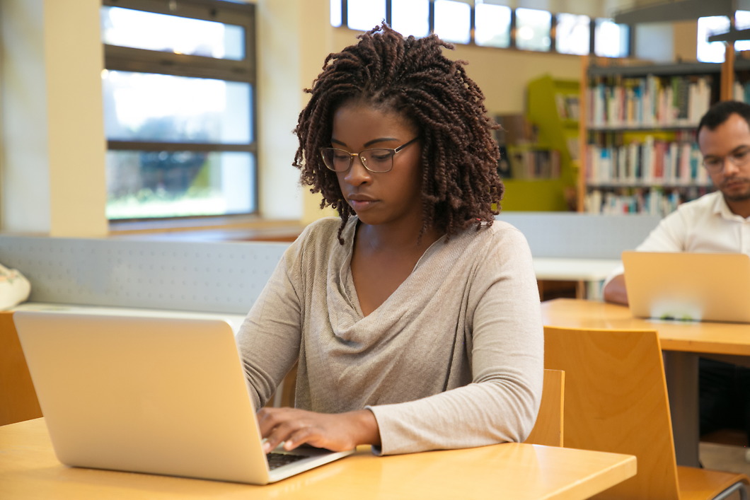 Focused student working in computer lab.