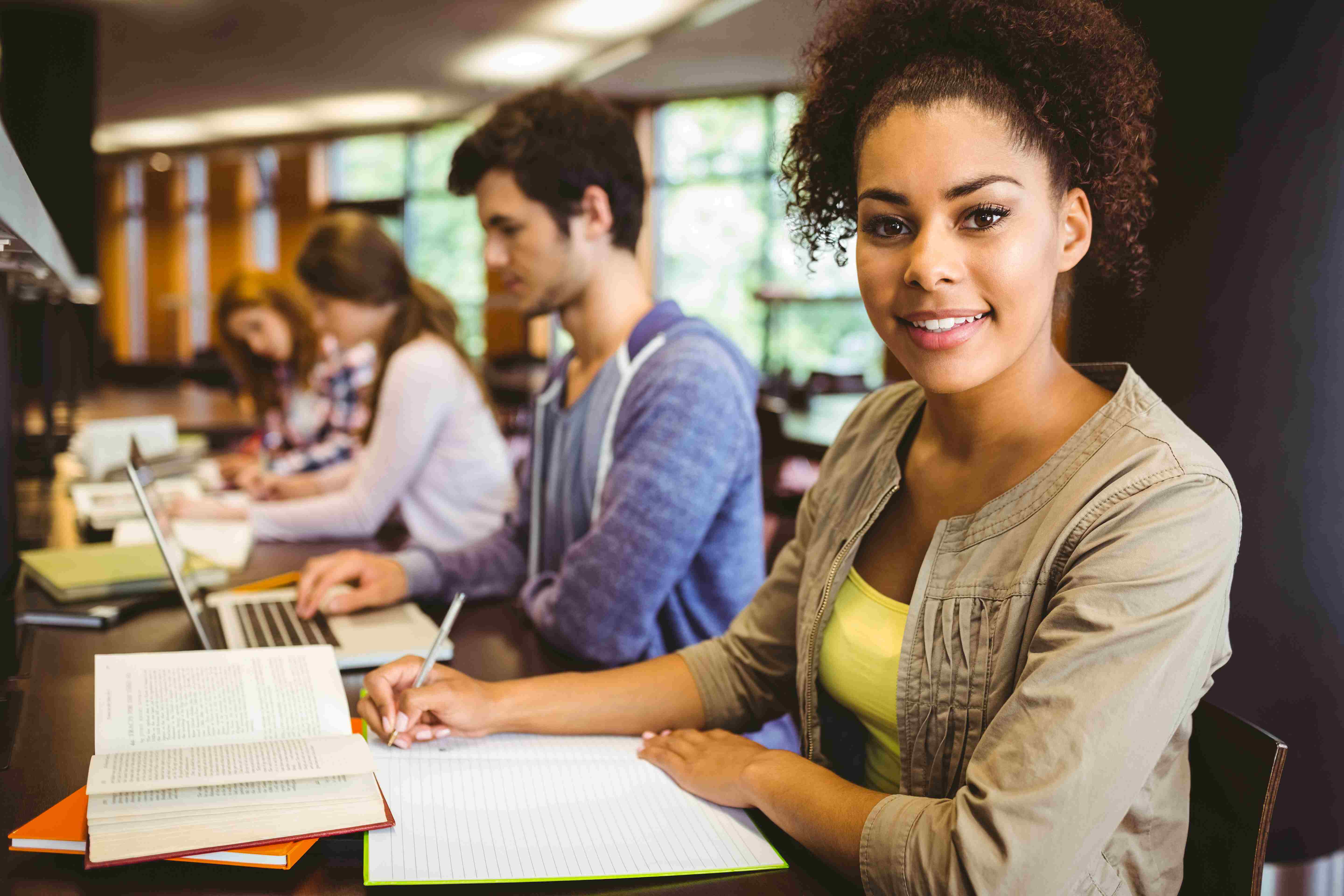 Students sitting at a table in a library.