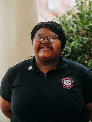 Portrait of Brooke smiling and wearing a black NCCU polo shirt.