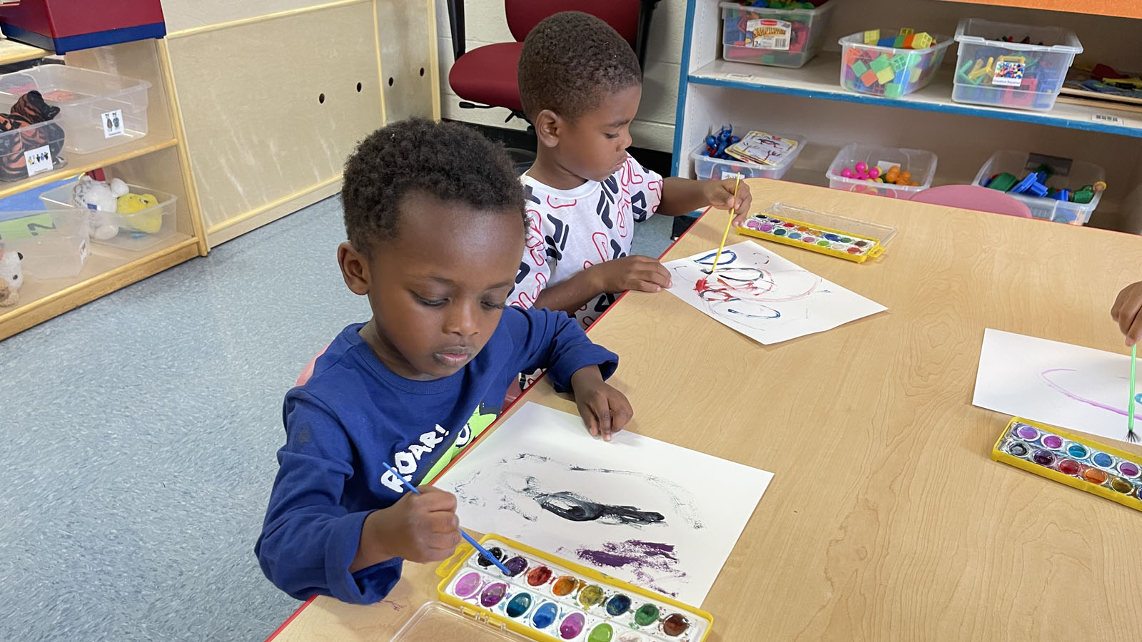 children painting a picture using paint