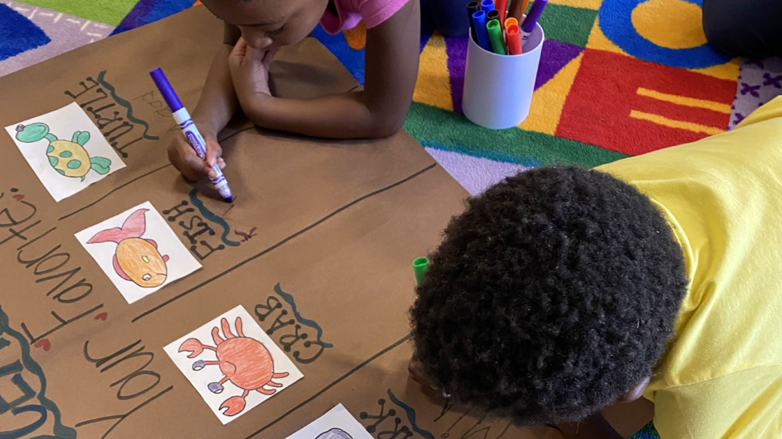 children practicing their writing by copying animal names