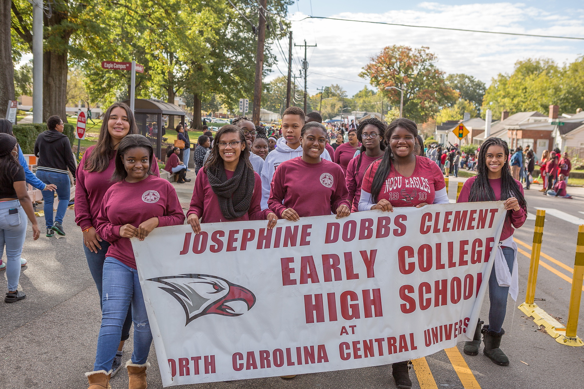 Early college students walking in a parade.