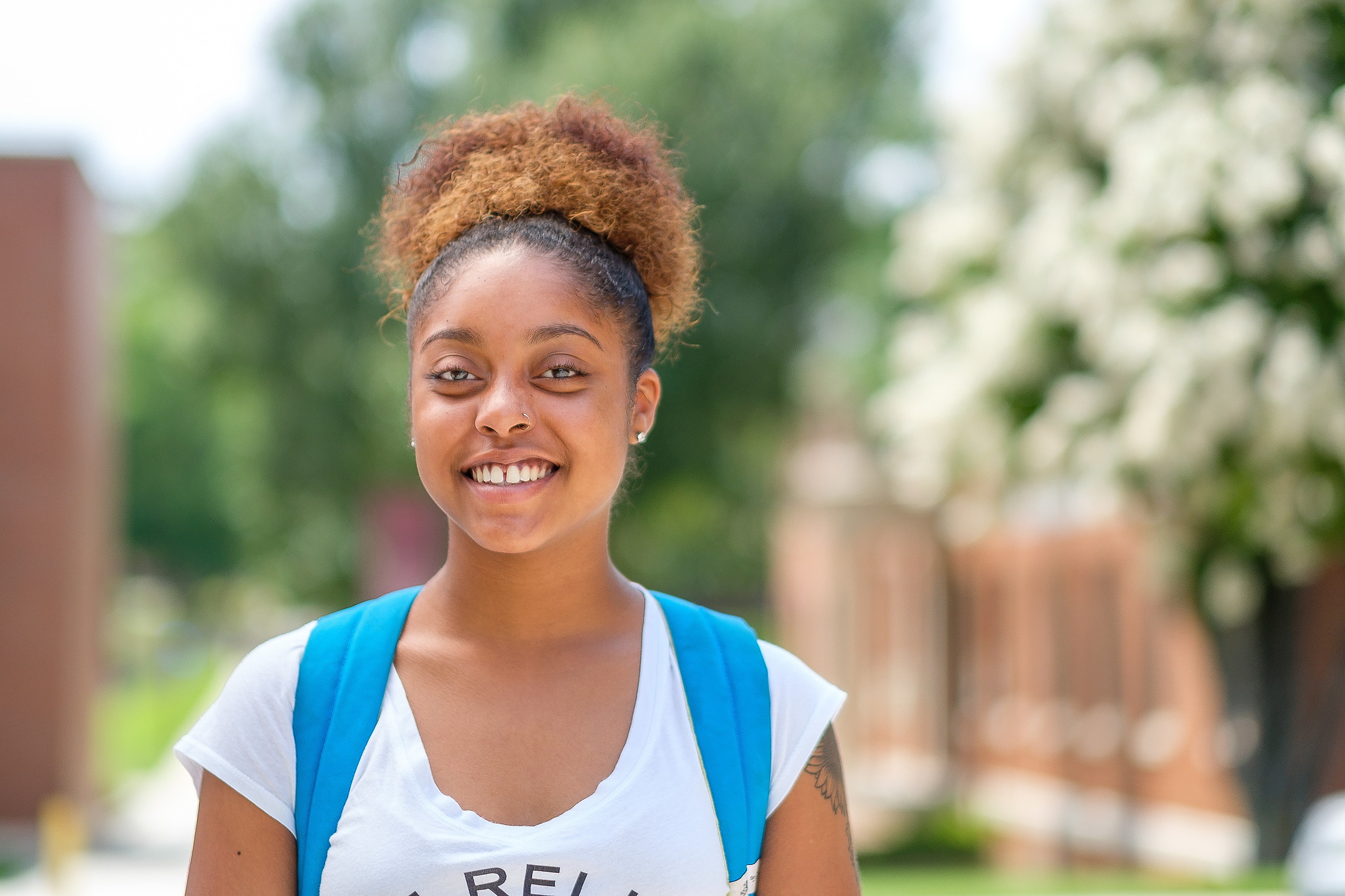 Student smiling outside