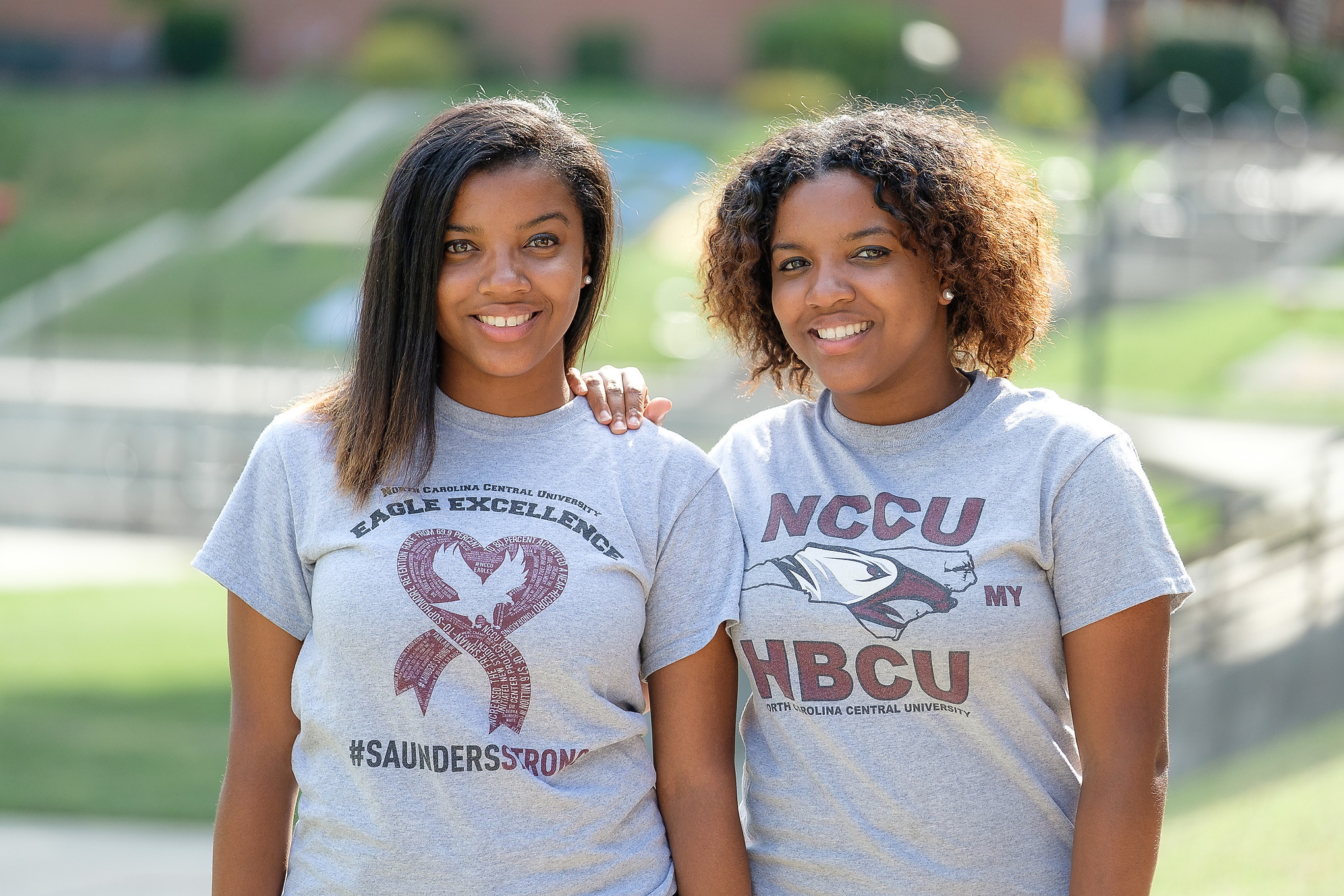 Two NCCU students standing outside looking into the camera.