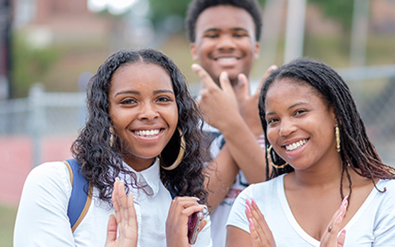 Students making eagle hand signs