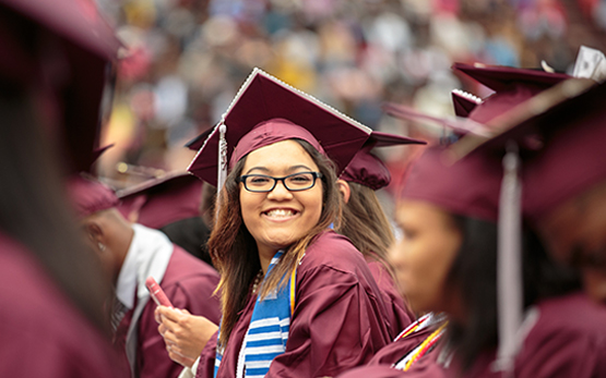 Graduate smiling at commencement