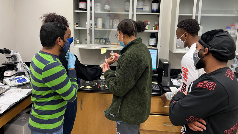 Highly qualified student, Briana,at ECSU training her peers on electrochemistry techniques.