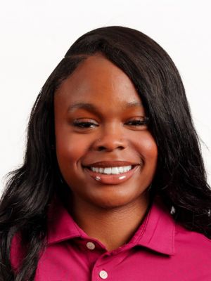 LaTara Walkder headshot portrait, smiling professional wearing a maroon collared shirt against a white background.