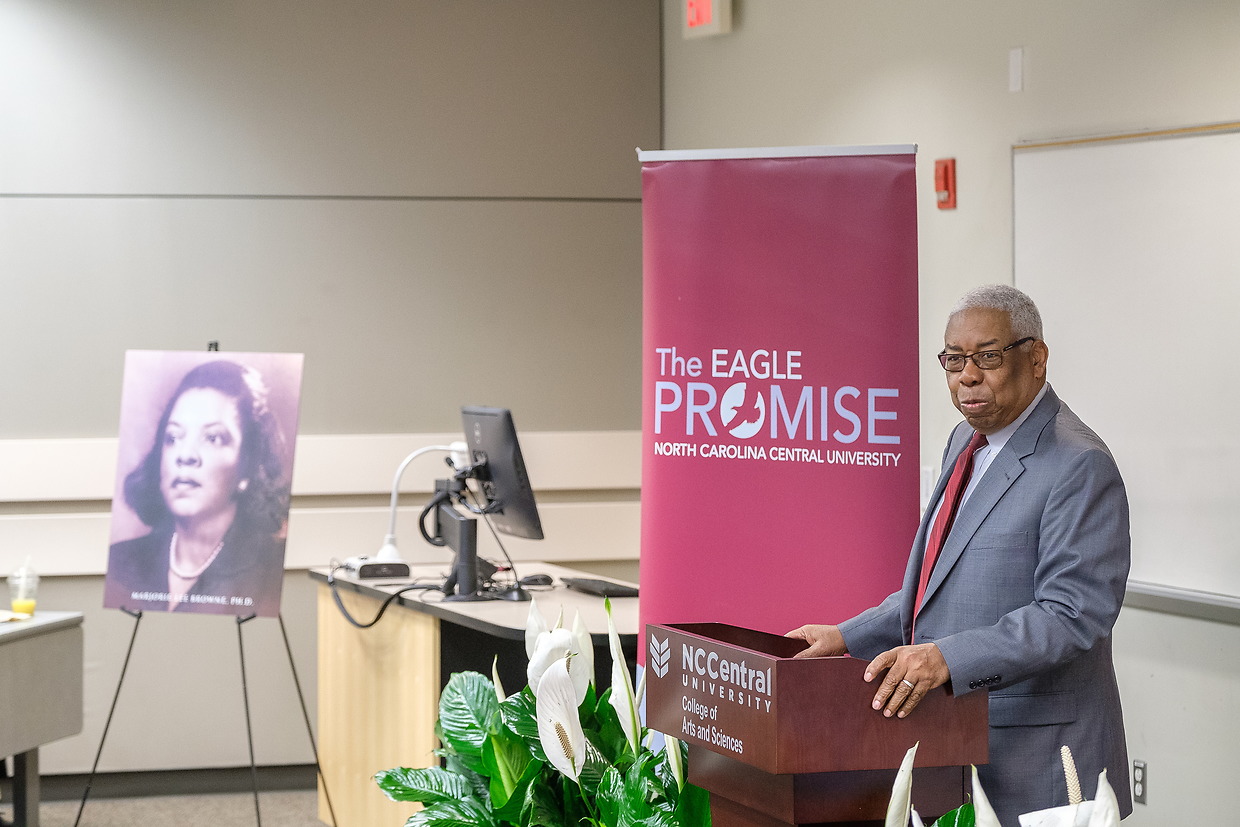 Orator giving a speech at a lecturn 