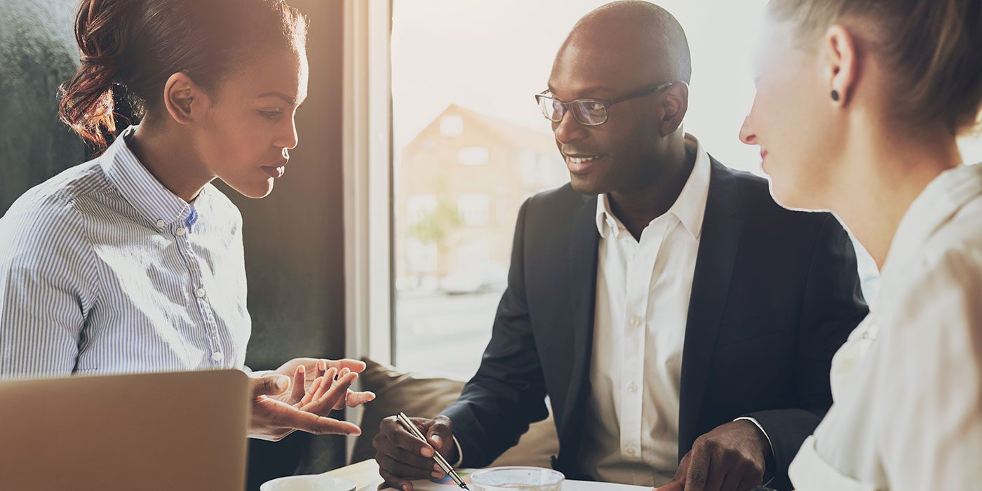 Stock image of people around a table working