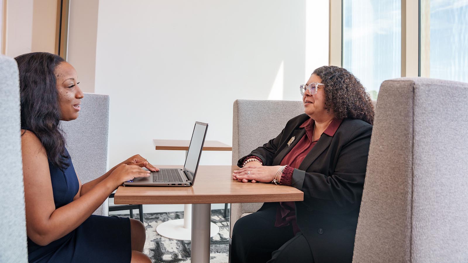 two formally dressed individuals sitting together, conversing