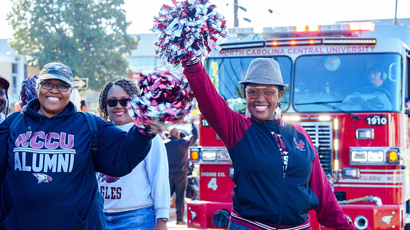 Homecoming parade - NCCU alumni holding up pompoms