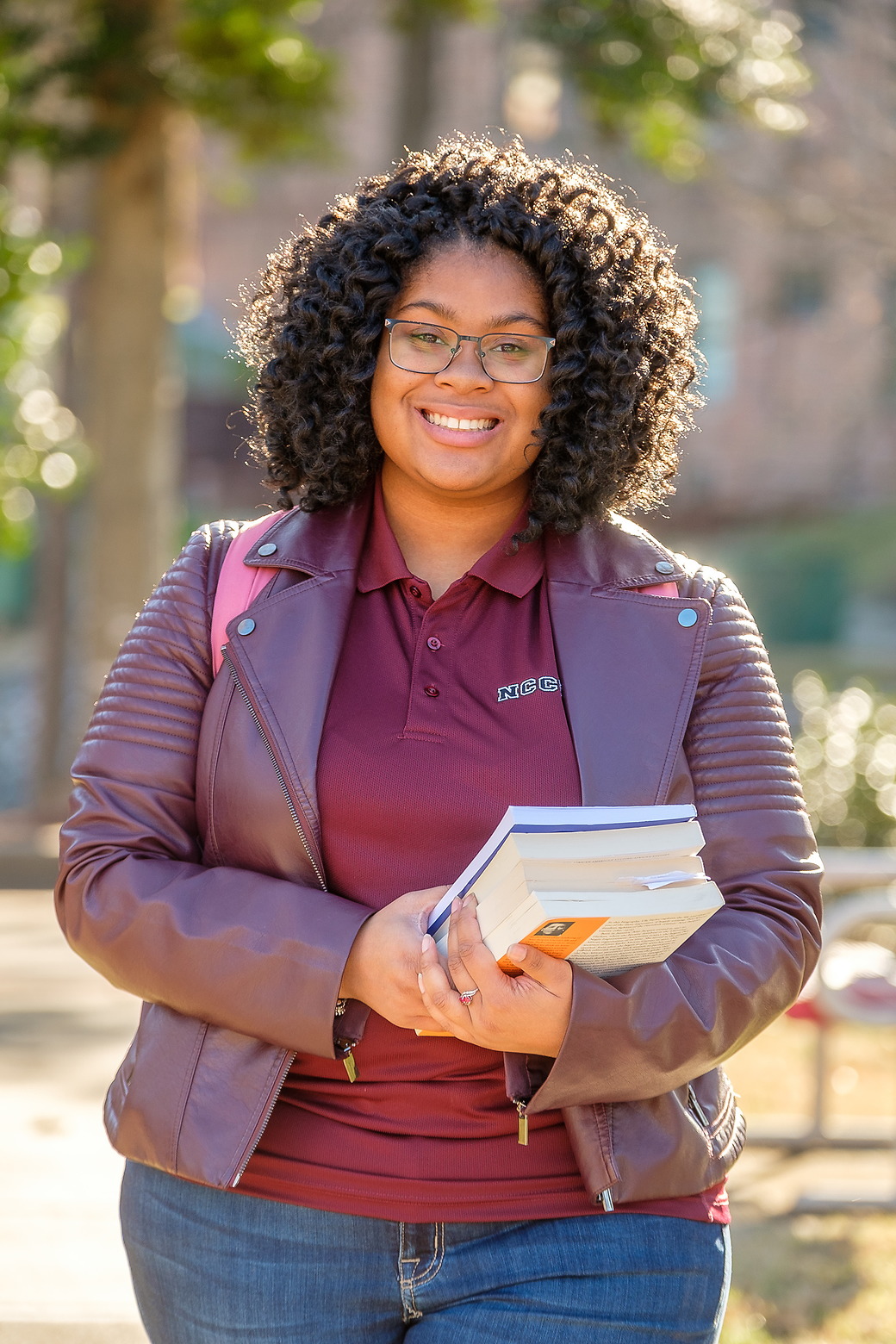 Woman standing alone holding a book