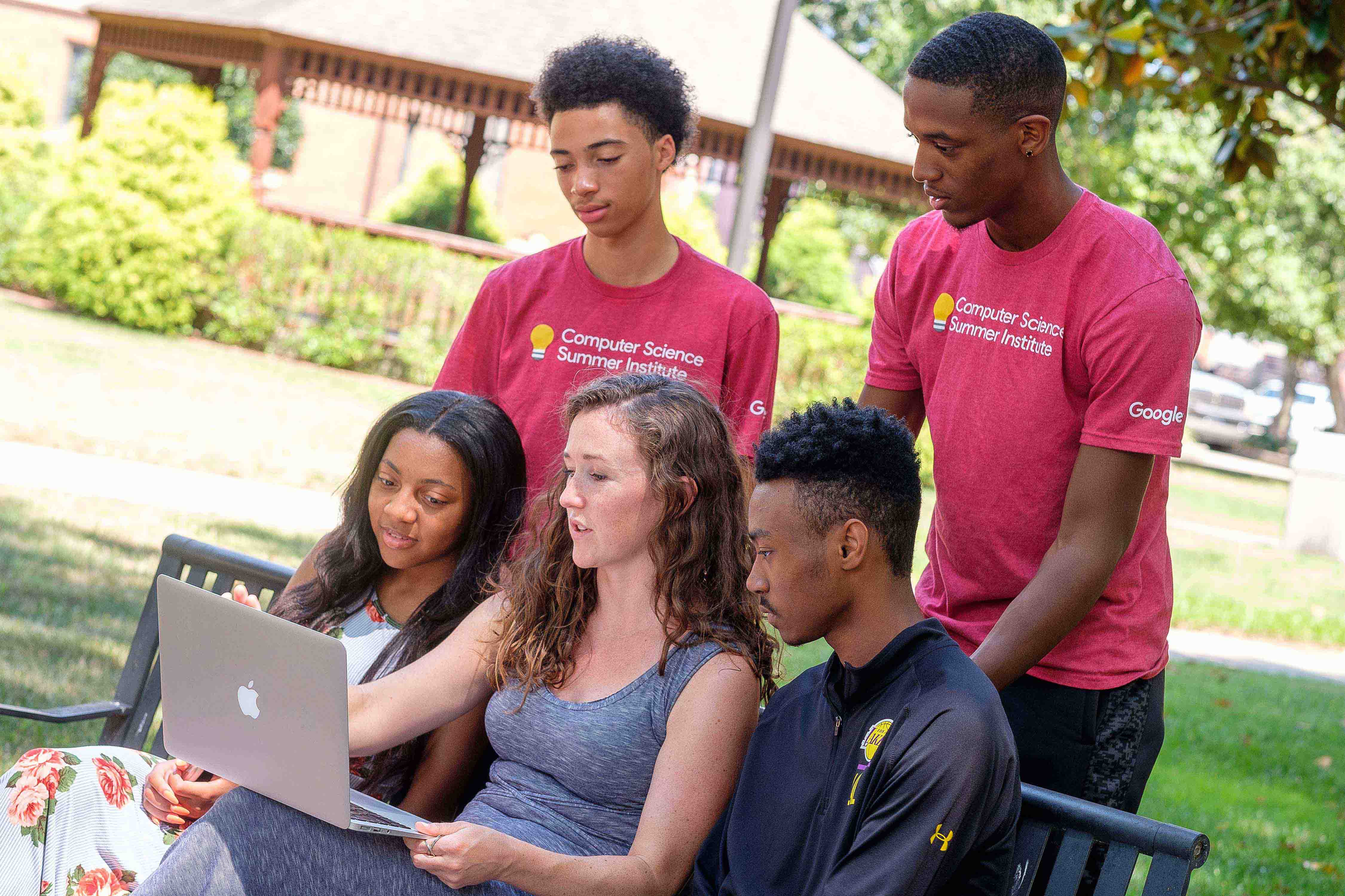 students outside on laptop