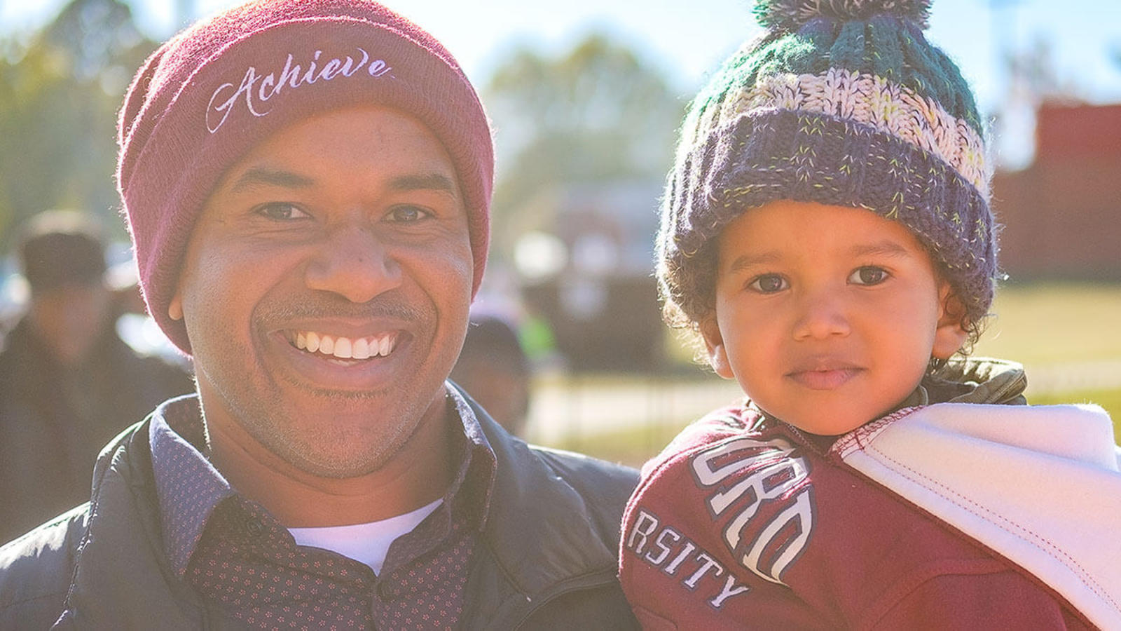 Father and Son smiling outside
