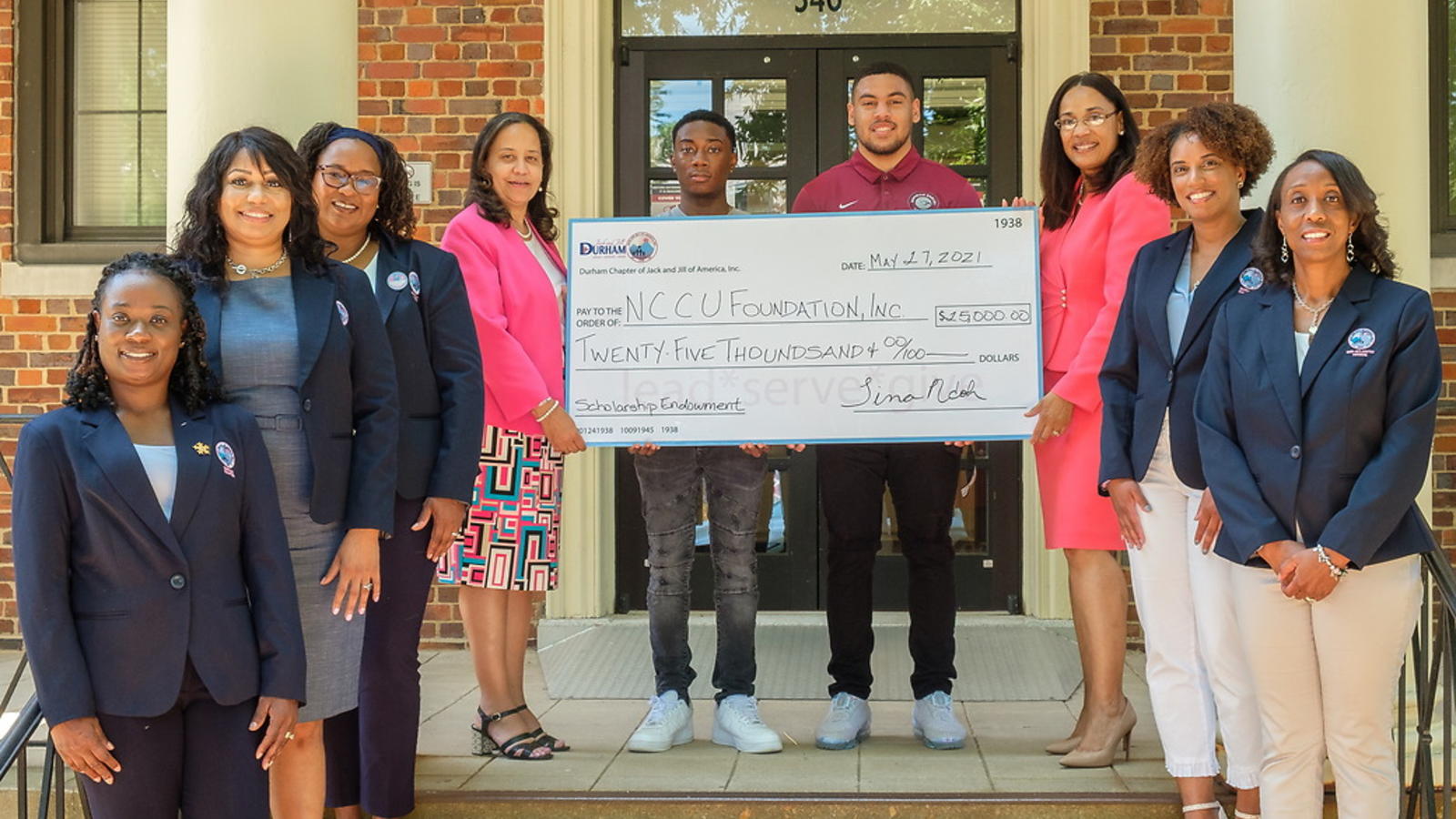 Institutional Advancement team holding Endowment Scholarship