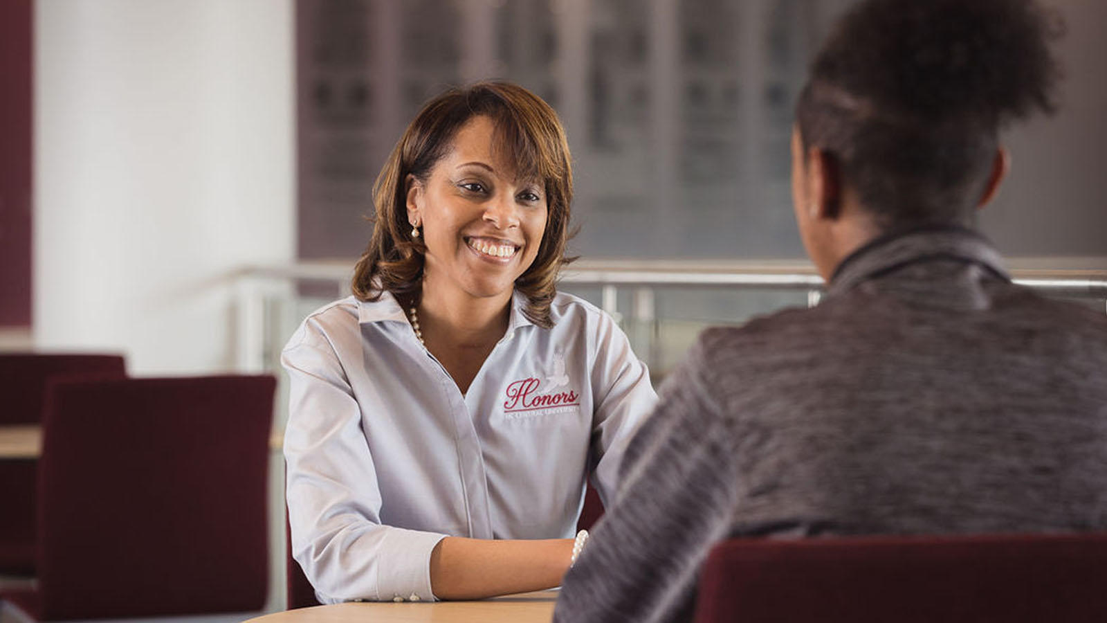 Dr. Jackson sitting across from a student, smiling