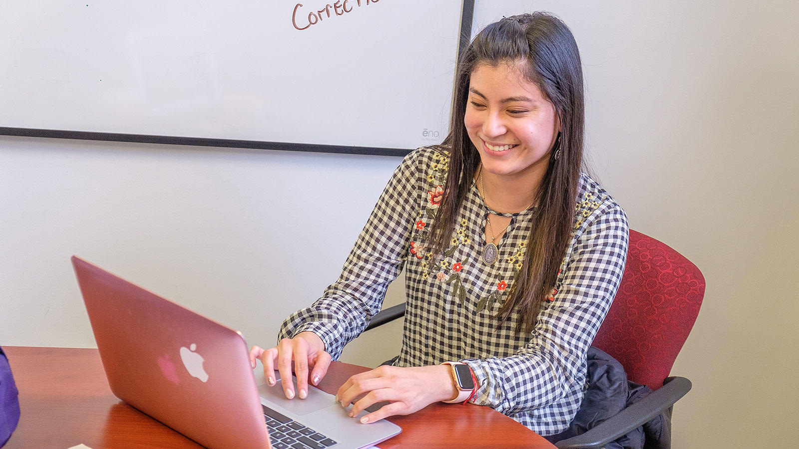 Girl Smiling while using Laptop