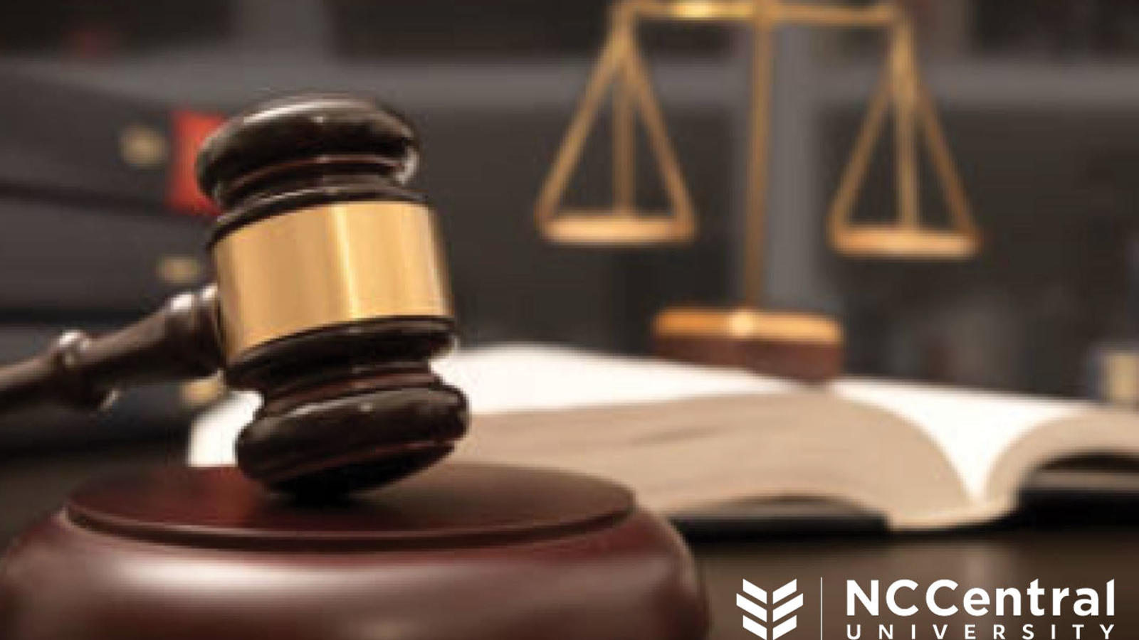 Stock image of a gavel and scales of justice on a desk
