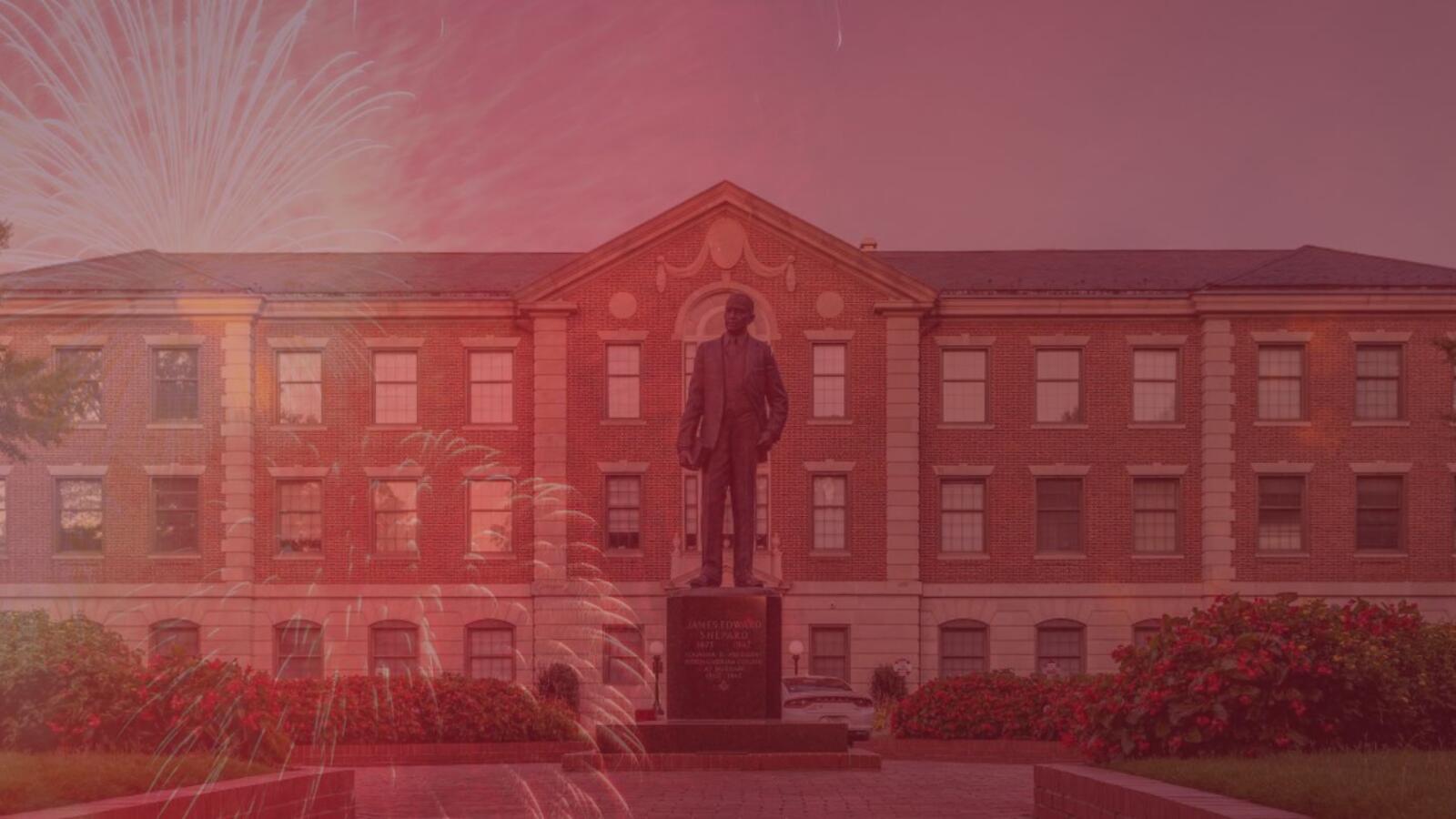 Image showing Dr. Shepard statue and administration building in the background with fireworks 
