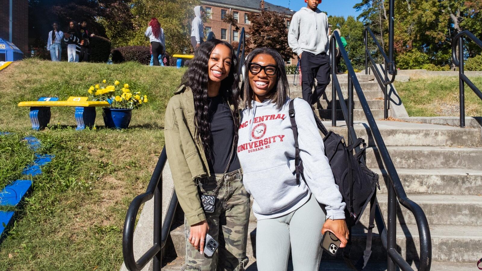 Two students smiling on the stairs