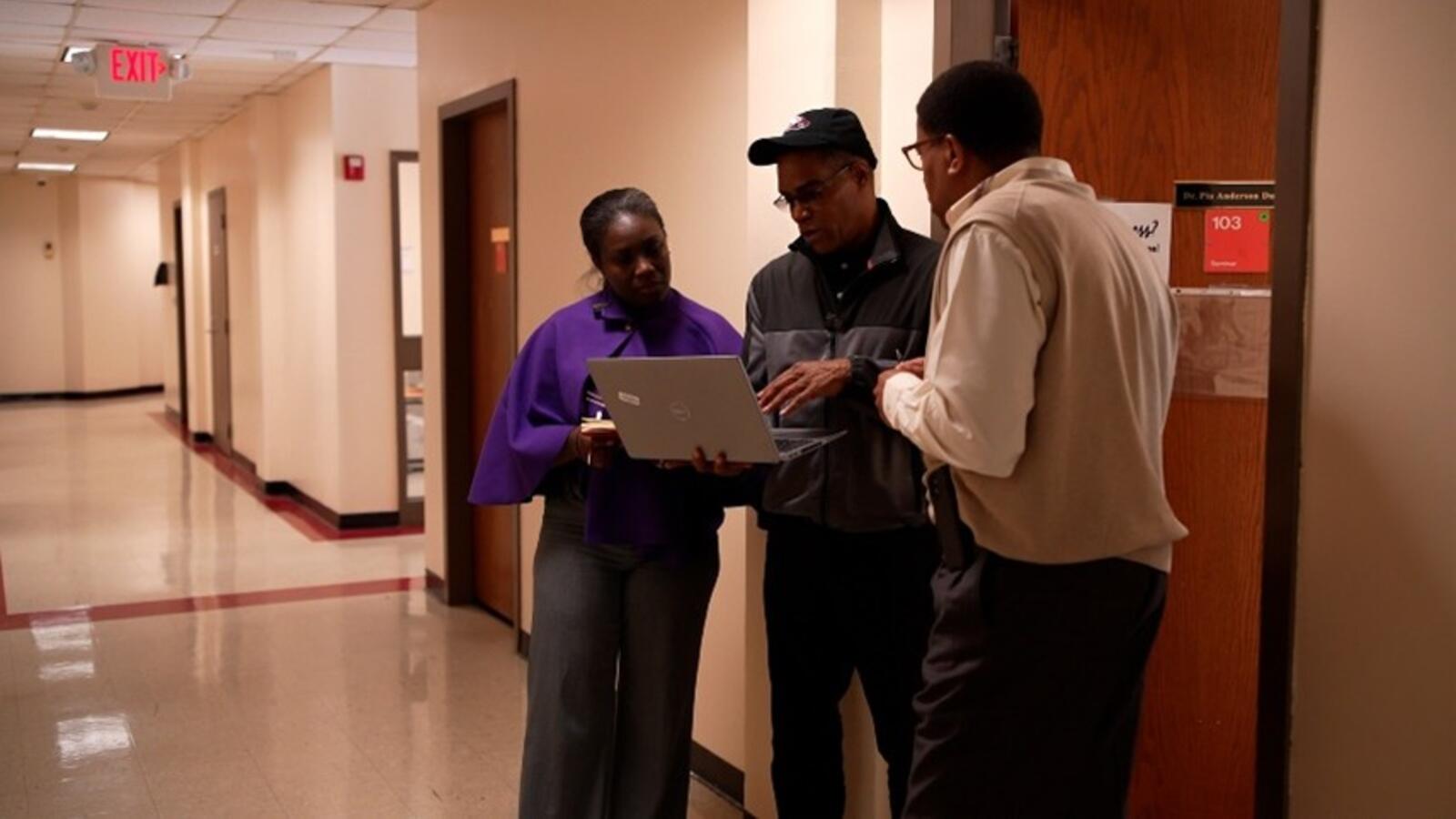 IHSEM team in hallway, talking