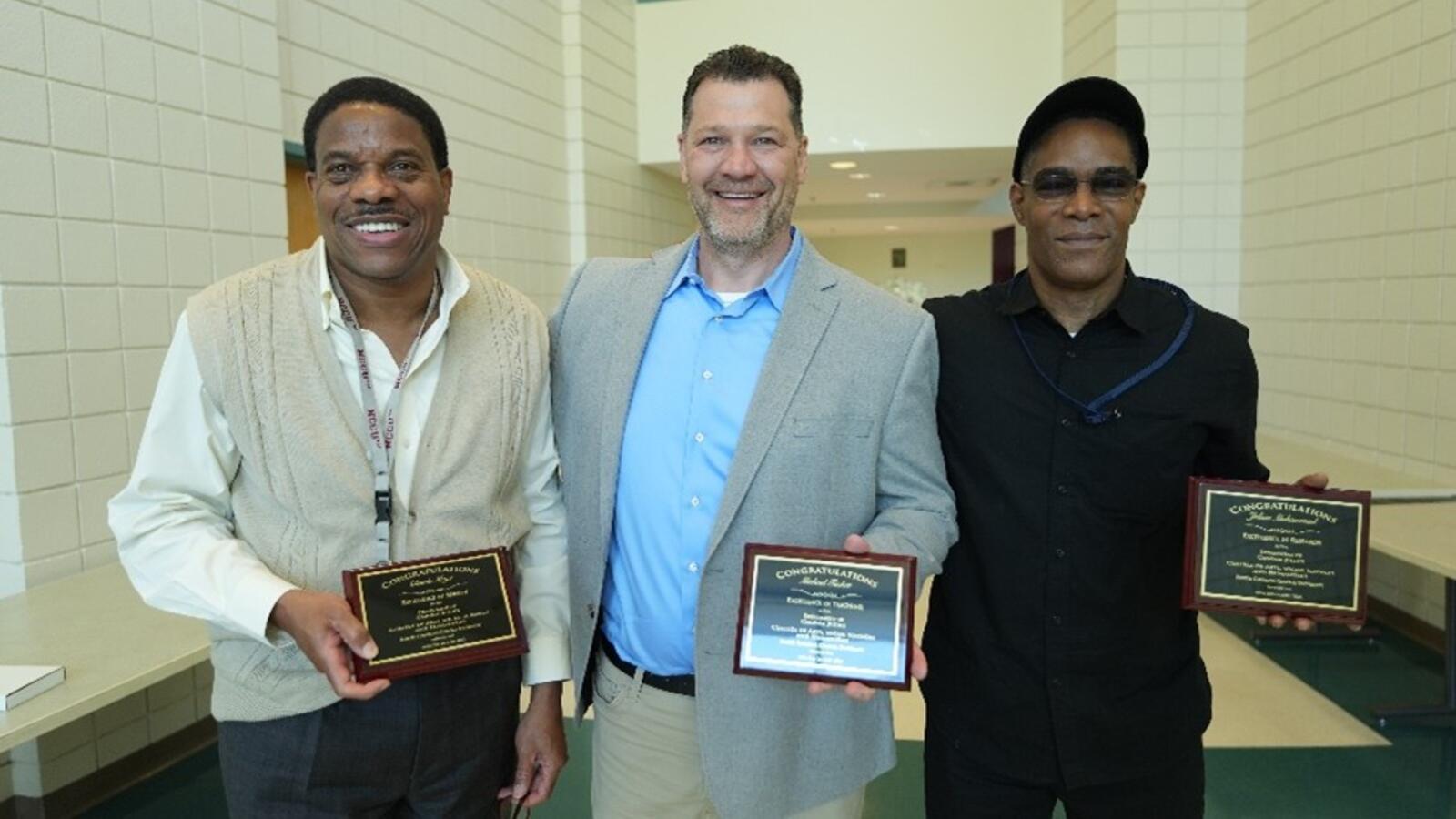 IHSEM team holding awards